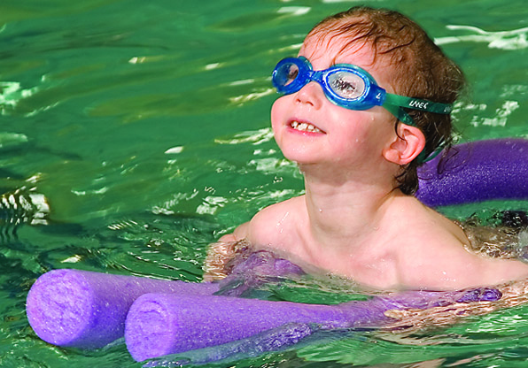 Boy on Noodle Swimming Class